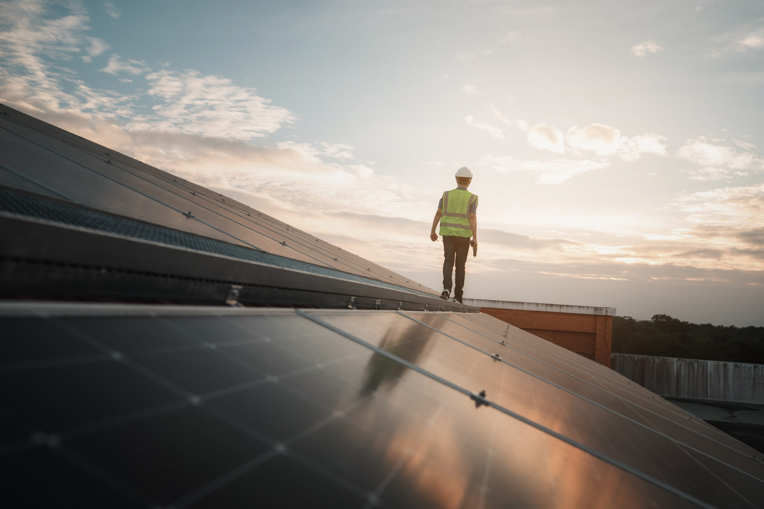 Service engineer checking solar cell on the roof for maintenance if there is a damaged part. Engineer worker install solar panel. Clean energy concept.