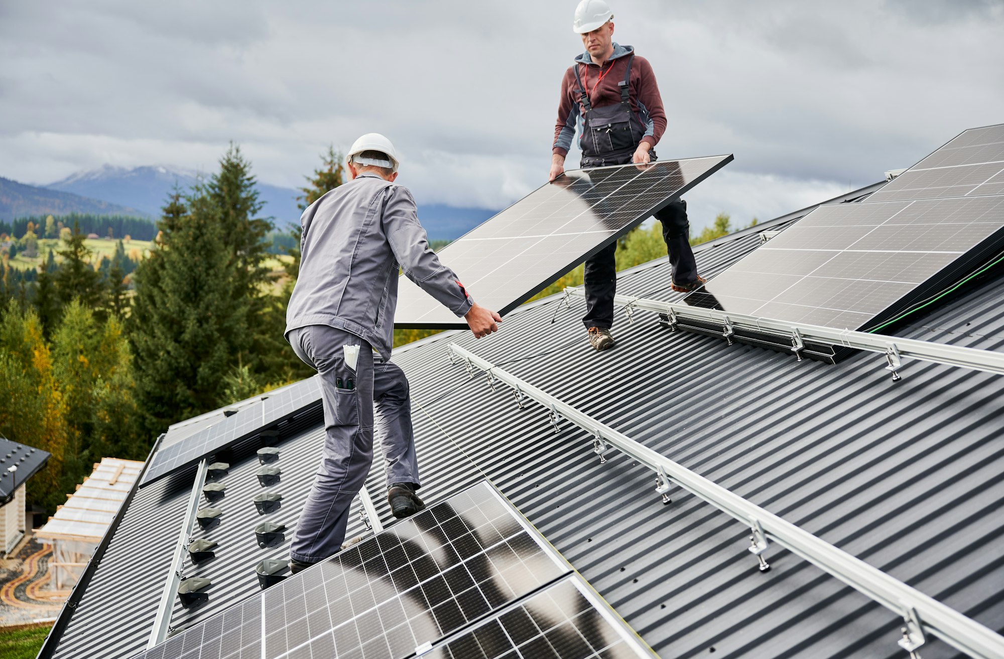 Professional technicians carrying solar PV battery